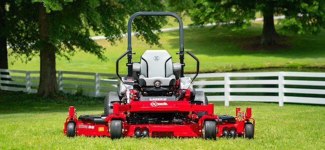 Exmark wide area mower on a fenced lawn